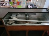 a sink that has a spoon and a spatula in it