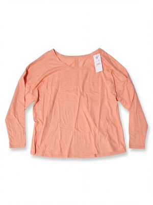 a women ' s long - sleeved t - shirt with a tag on the chest
