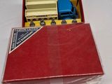 a red box with a toy truck inside of it