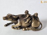 a figurine of a man riding a horse with two children on it