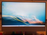 a computer monitor sitting on top of a desk