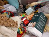 a pile of toys and books on a bed