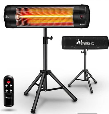 a close up of a heater sitting on top of a tripod next to a remote control