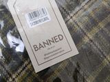 a label that says banned on a plaid fabric