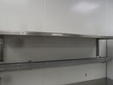 a stainless steel shelf in the middle of a kitchen