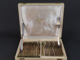 a box with silverware in it on a black surface