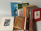 several books are stacked on top of each other on a white surface