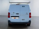 a white van parked in a room with a white wall