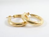 a pair of gold hoop earrings on a white background