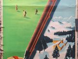 a poster on the side of a building advertising a game of golf
