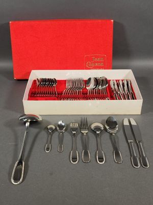 a red box with silverware in it on a table