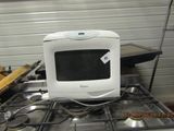 a microwave sitting on top of a stove in a kitchen