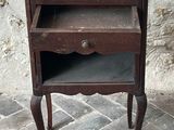 a small wooden table with a drawer on top of it