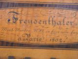 a plaque on the side of a wooden table