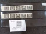 three stamps on a table with a price tag and a sticker