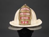 fireman ' s helmet on a mannequin head on a black surface