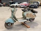 a scooter that is sitting on a stand in a parking lot