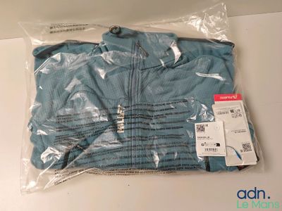 a blue shirt in a plastic bag on a table