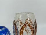 two glass vases sitting next to each other on a table