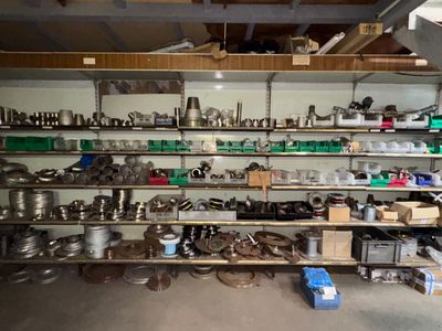 a room filled with lots of pots and pans on the shelves