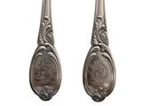 pair of antique silverware spoons on a white background