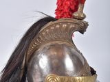 a helmet with a red mohawk sitting on top of a wooden stand