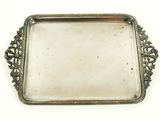 an antique silver tray with a decorative design on it