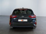 the rear end of a black car in a white room