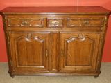 an antique oak sideboard with two drawers and two doors