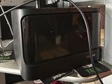 a microwave sitting on top of a shelf with a flower in it