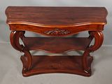 a wooden table with a shelf on top of it