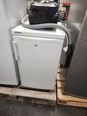 two refrigerators and a freezer in a room