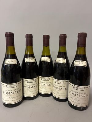 six bottles of wine are lined up on a table
