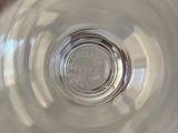 a person holding a glass of water in their hand