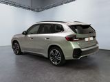 the rear end of a silver 2020 bmw x1 parked in a garage