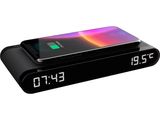 an image of a black alarm clock with a phone on it
