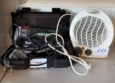 a white fan sitting on top of a counter next to a black case