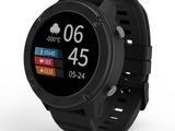 une montre connectée noire posée sur une surface blanche, avec un fond blanc