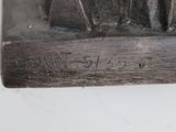 a statue of a man sitting on top of a table