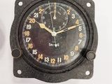 a clock that is on the wall next to a wall clock