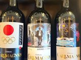 several bottles of wine are lined up in a row on a shelf