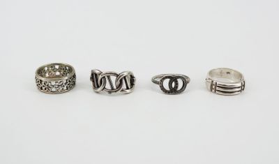 three silver rings on a white surface with a white background