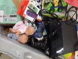 a pile of toys and other items in a bin on the floor