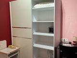 an image of a small room with a desk and a bookcase