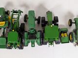 a lot of toy tractors that are sitting on a table
