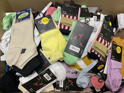 many pairs of socks in a box on the floor