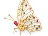 a close up of a butterfly brooch with colored stones on it