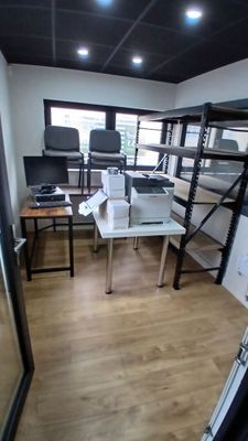 an image of a room with a desk and shelves