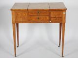 a small wooden table with drawers on it