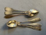 three spoons that are sitting on a table